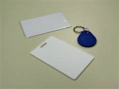 A photograph of three RFID tags. Two credit card sized, and they other on key chain fob.