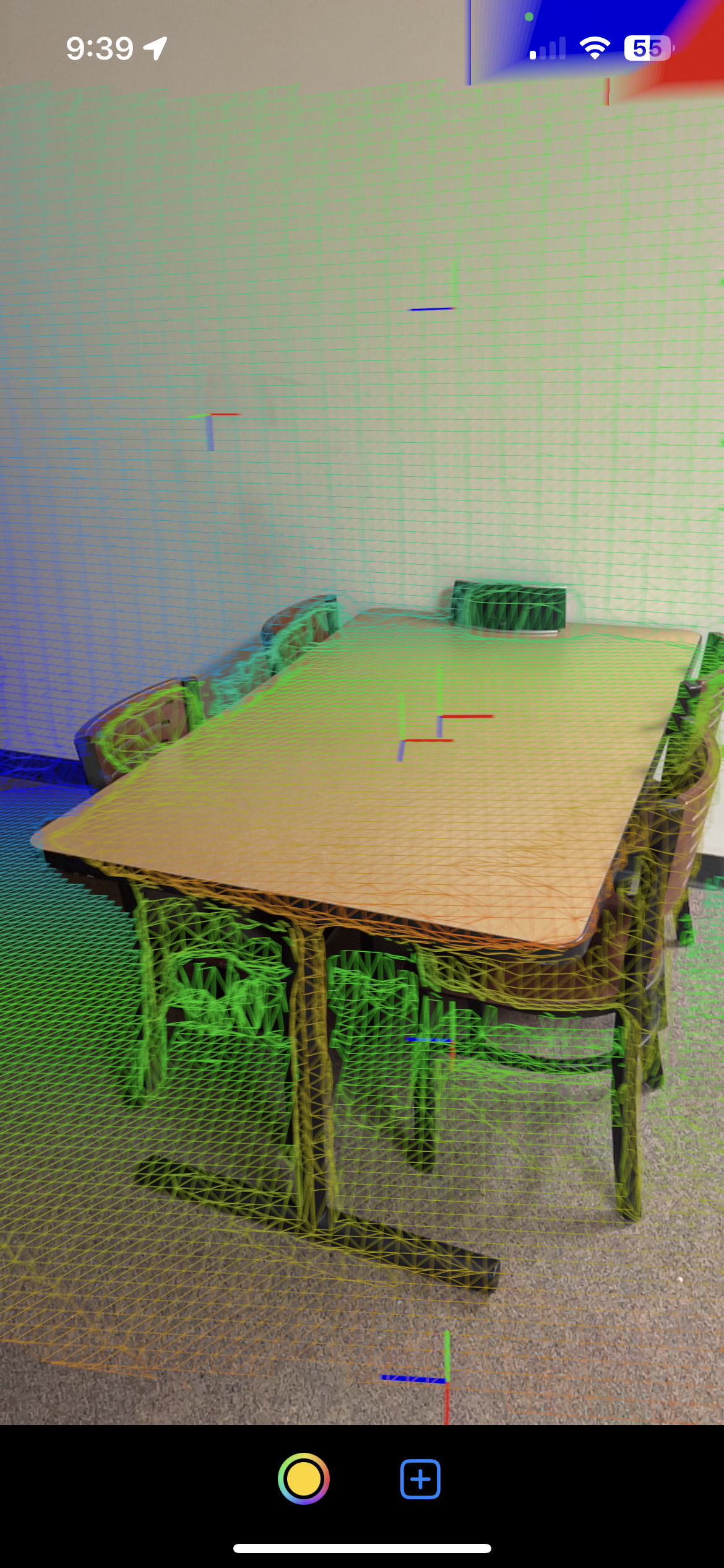 A table in my apartment. In the picture, there are special debug objects like the mesh and the anchors that help to show the understanding of what AR View sees and how scene reconstruction is working.