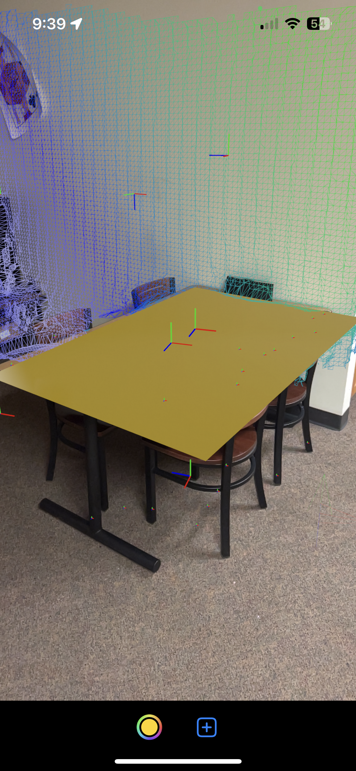 A table in my apartment. In the picture, there is a 2D object made using a simple material type from Reality Kit.